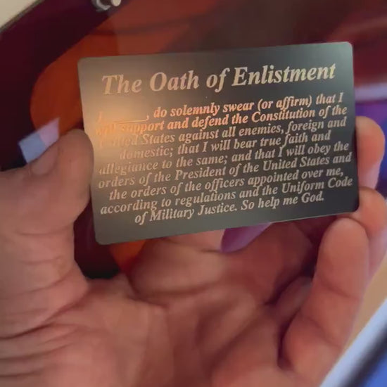 Close up video of hand holding a laser engraved metal commemorative gift cue flash card with The Oath of Enlistment text