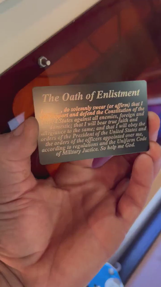 Close up video of hand holding a laser engraved metal commemorative gift cue flash card with The Oath of Enlistment text