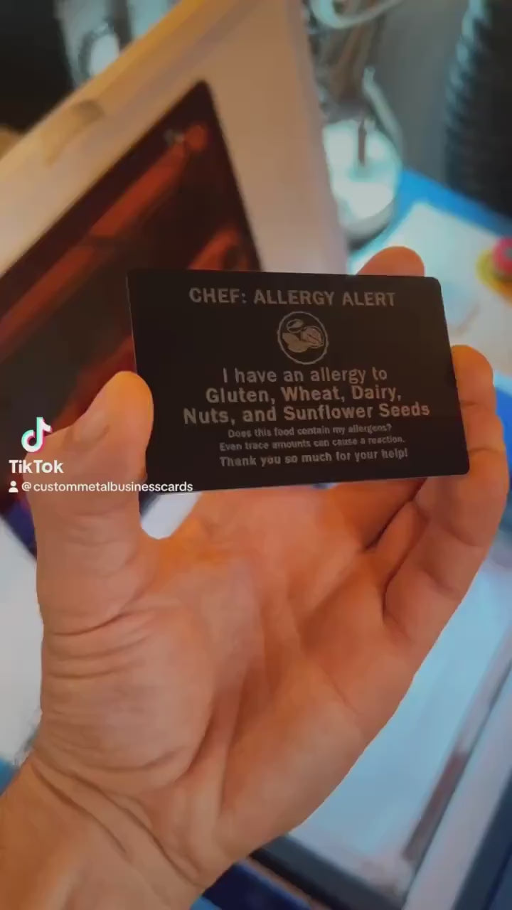 Close up video of hand holding a laser engraved metal gift card with Chef: Allergy Alert, I have an allergy to Gluten, Wheat, Dairy, Nuts, and Sunflower Seeds. Does this food contain my allergens? Even trace amounts can cause a reaction. Thank you so much for your help! 