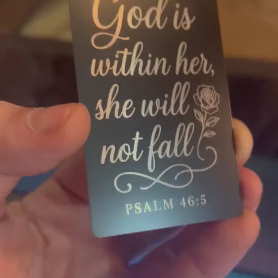 Laser engraved metal keepsake card that reads in elegant typography: God Is Within Her, She Will Not Fall, with a bible verse reference for Psalm 46:5 below