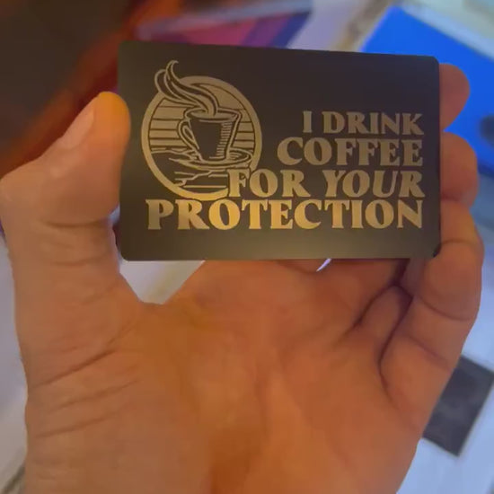 Video of engraved metal coffee protection funny novelty gift card turning under light to show reflective finish