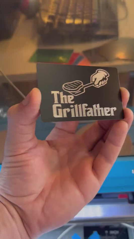 Video of engraved metal wallet Grill Father card turning under light to show reflective finish