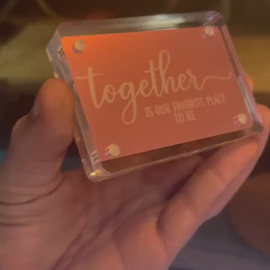 Hand showcasing a rose gold "Together Is Our Favorite Place To Be" metal couples gift card, cute anniversary gift