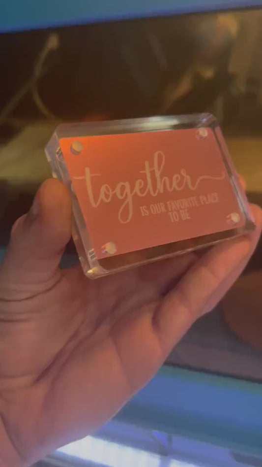Hand showcasing a rose gold "Together Is Our Favorite Place To Be" metal couples gift card, cute anniversary gift