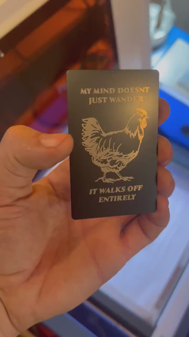 laser engraved metal gift card that reads "My Mind Doesn't Just Wander, It Walks off Entirely" with silly farmhouse chicken graphic graphic