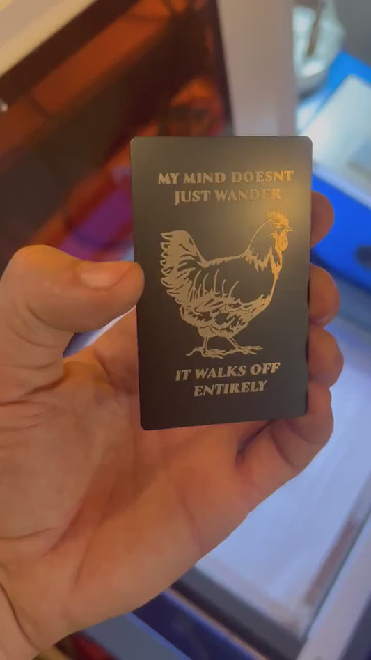 laser engraved metal gift card that reads "My Mind Doesn't Just Wander, It Walks off Entirely" with silly farmhouse chicken graphic graphic