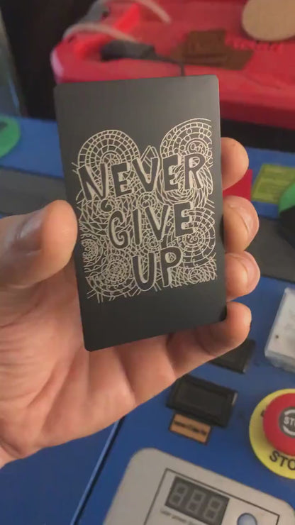Laser engraved metal motivational reminder keepsake that reads Never Give Up with psychedelic pattern print