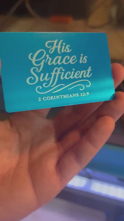 Hand holding a laser engraved metal wallet insert card that has inspirational Christian inspired typography and bible verse reference