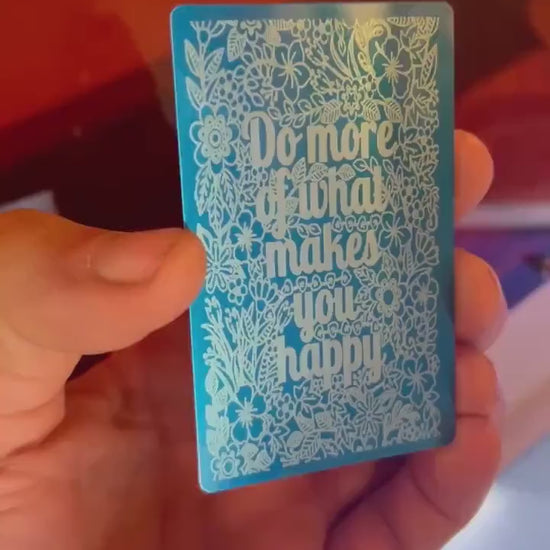 Laser engraved blue/silver novelty keepsake gift that reads Do More of What Makes You Happy, in blue/silver anodized aluminum