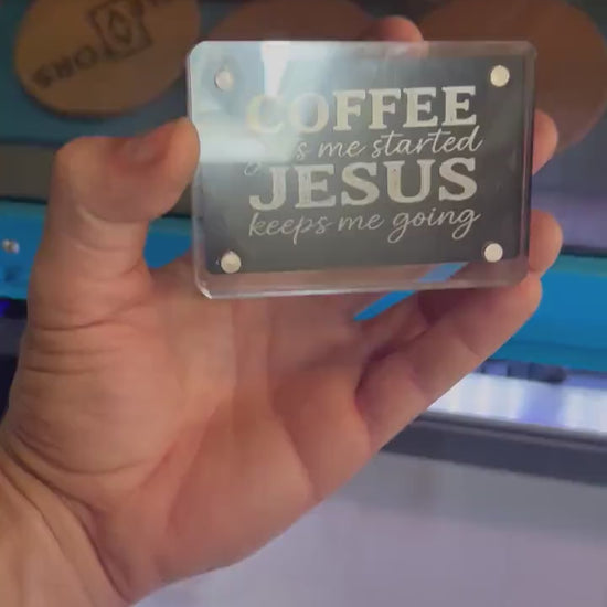 Detailed shot of engraved anodized aluminum inspirational card featuring “COFFEE gets me started JESUS keeps me going” text
