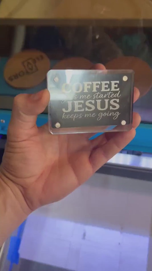 Detailed shot of engraved anodized aluminum inspirational card featuring “COFFEE gets me started JESUS keeps me going” text