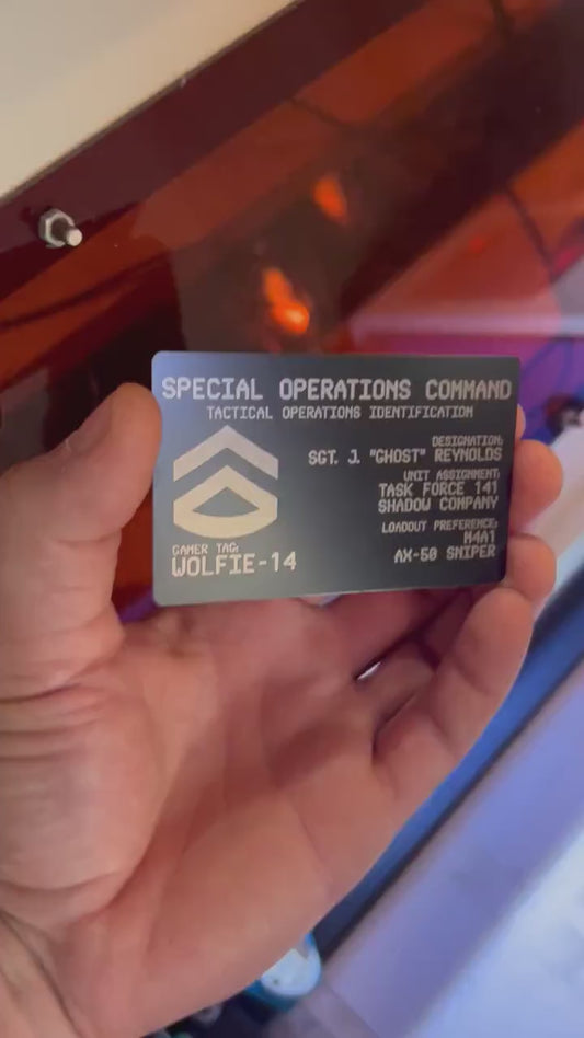 Hands rotating personalized metal business card to display engraved personalized FPS gaming text