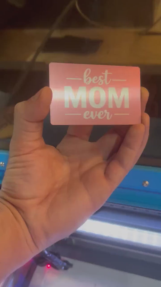Hand holding a laser engraved rose gold/silver metal best mom ever mother's day keepsake gift card