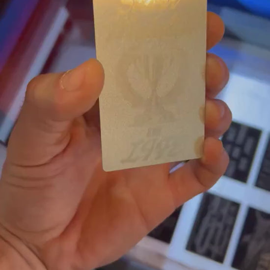 Video of engraved metal wallet card turning under light to show reflective finish
