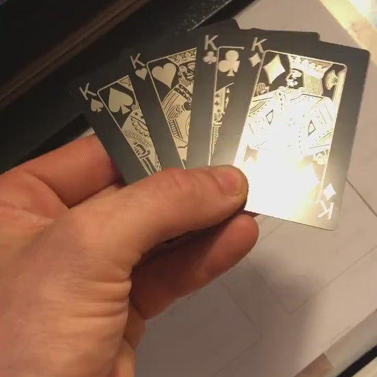 Close up video of hand holding 4 laser engraved metal poker gift cards with King of Spades, King of Hearts, King of Clubs and King of Diamonds cards