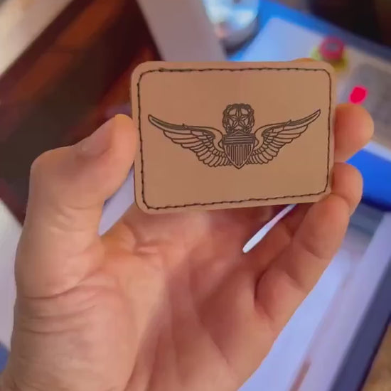 video of hand holding a laser engraved flight patch leather engraving