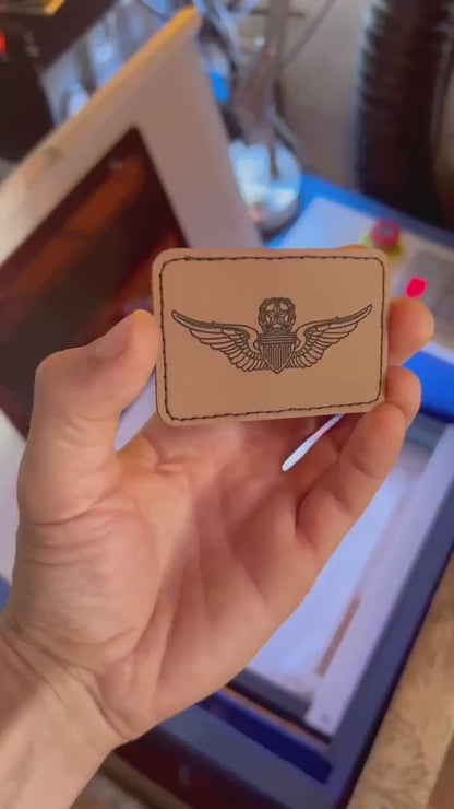video of hand holding a laser engraved flight patch leather engraving