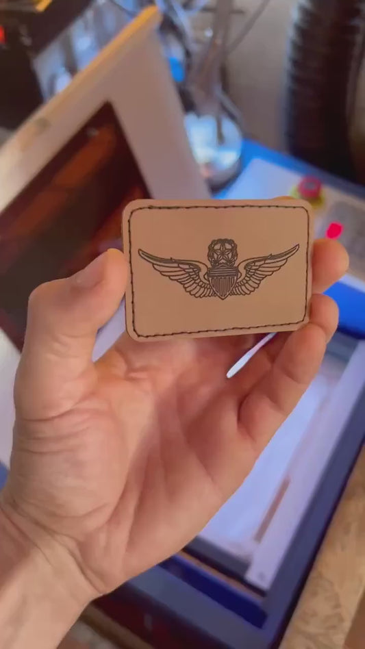 video of hand holding a laser engraved flight patch leather engraving