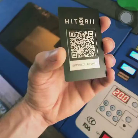 Laser engraved metal QR code card, demonstrated with scannable code on camera app