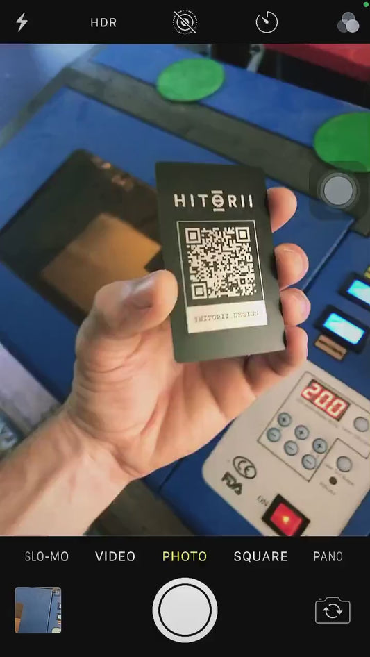 Laser engraved metal QR code card, demonstrated with scannable code on camera app