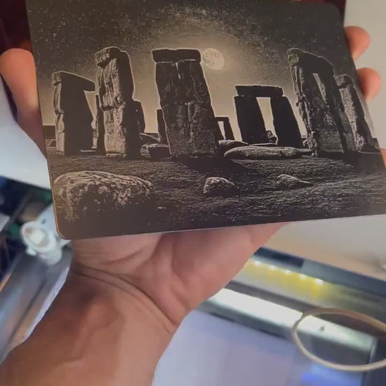 Hand holding a laser engraved 5x7 metal plaque with Stonehenge engraving art
