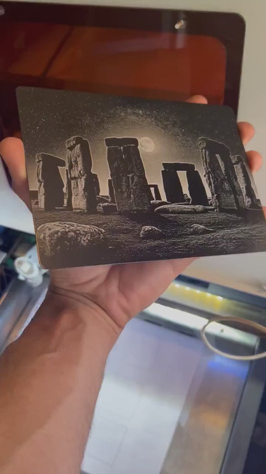 Hand holding a laser engraved 5x7 metal plaque with Stonehenge engraving art