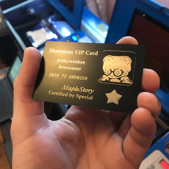 Close up video product demonstration with hand holding a laser engraved black/silver metal business card, with Custom Metal Business Cards logo branding