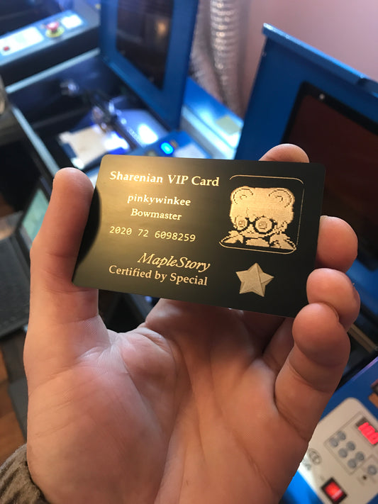 Close up video product demonstration with hand holding a laser engraved black/silver metal business card, with Custom Metal Business Cards logo branding