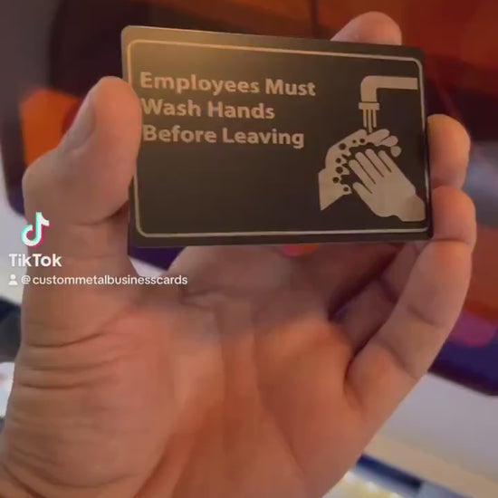 Video of hand demonstrating the Laser engraved metal retail signage with Employees Must Wash Hands Before Leaving graphic