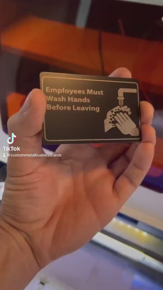 Video of hand demonstrating the Laser engraved metal retail signage with Employees Must Wash Hands Before Leaving graphic