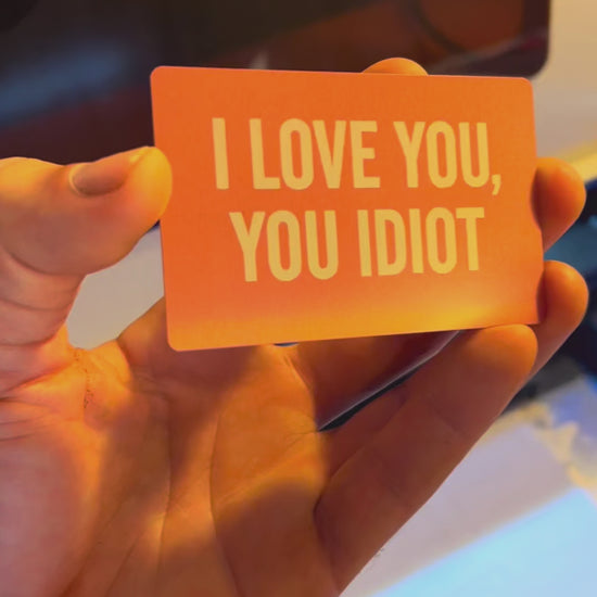 Laser engraved rose gold anodized aluminum romantic gift card with "I love you, You idiot" text