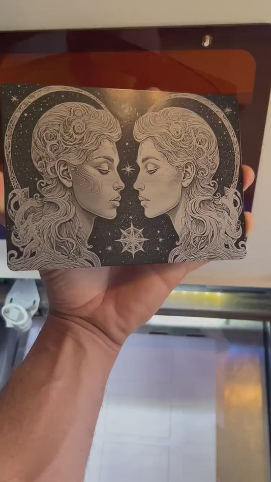 hand holding a metal 7x5 plaque with gemini twins laser engraving psychedelic artwork, rotating back and forth to show reflective qualities