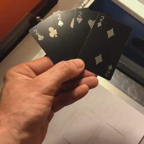 Custom anodized aluminum 2 of clubs, spades, heart snd diamonds playing card being rotated to highlight engraving design