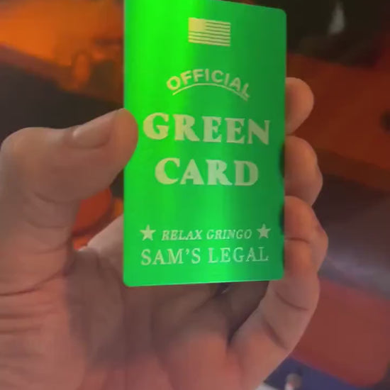 Close up video of hand holding a laser engraved metal gift card with "Official" green card, and personalized name reading "Relax Gringo, Sam's Legal" for the custom field, shown in green/silver anodized aluminum