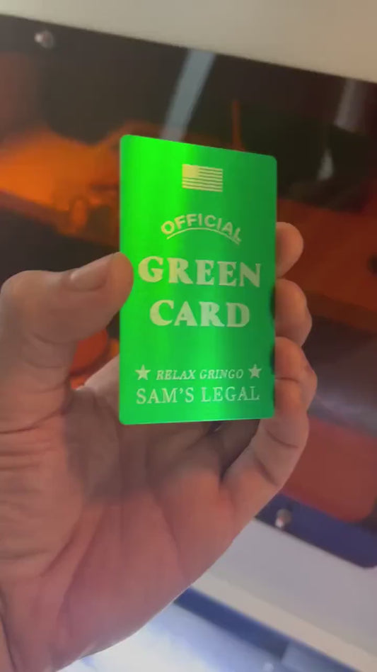 Close up video of hand holding a laser engraved metal gift card with "Official" green card, and personalized name reading "Relax Gringo, Sam's Legal" for the custom field, shown in green/silver anodized aluminum