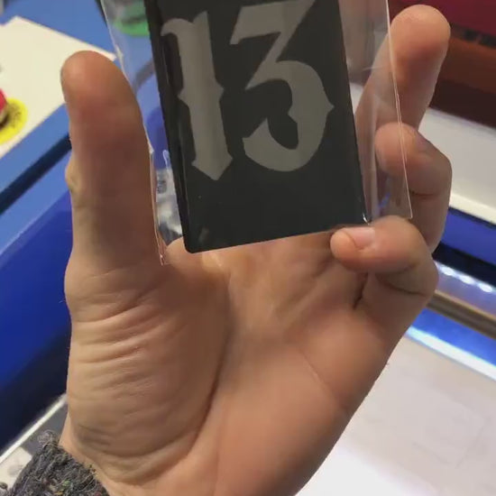 Custom anodized aluminum card being rotated to highlight the number 13 gothic typography design