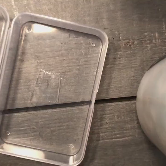 Video of metal tarot cards being put into a protective shipping case one after the other, demonstrating multiple metal tarot card designs