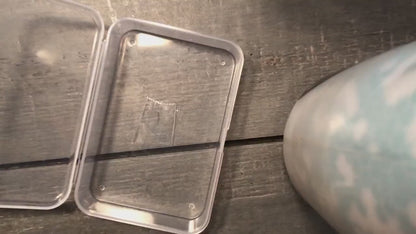 Video of metal tarot cards being put into a protective shipping case one after the other, demonstrating multiple metal tarot card designs