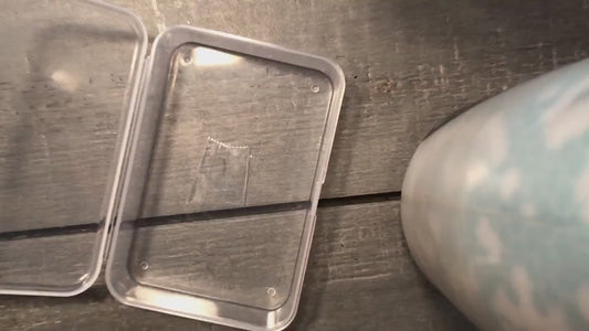Video of metal tarot cards being put into a protective shipping case one after the other, demonstrating multiple metal tarot card designs