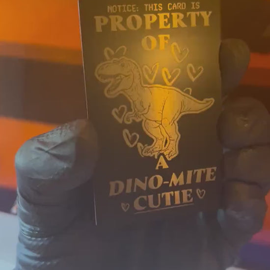 Video of engraved metal property of a cutie wallet card turning under light to show reflective finish