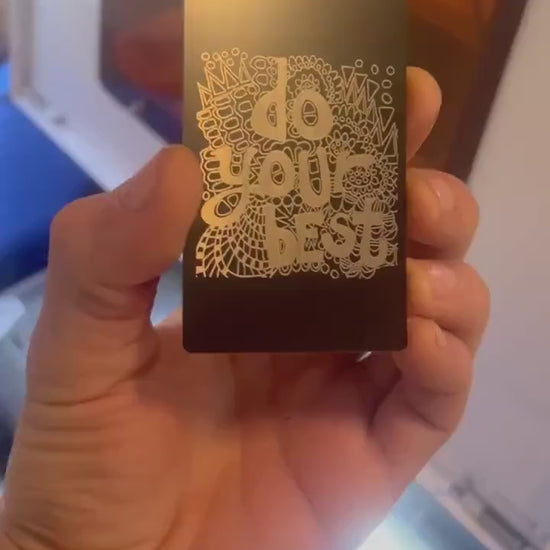 Showcasing laser engraved metal keepsake inspirational keepsake plaque that reads "Do Your Best" on psychedelic pattern