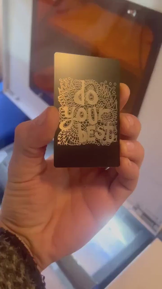 Showcasing laser engraved metal keepsake inspirational keepsake plaque that reads "Do Your Best" on psychedelic pattern