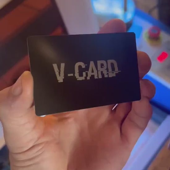 Close up video of hand holding a laser engraved metal gift card with V Card funny sarcastic text