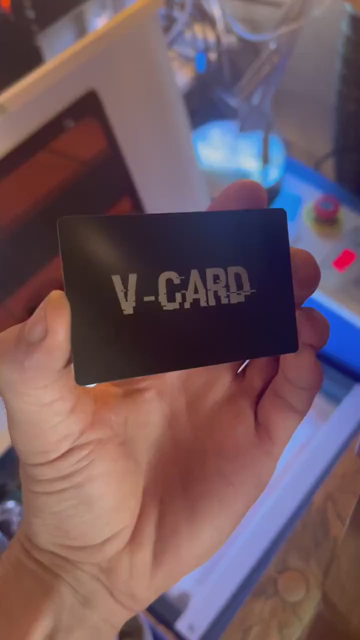 Close up video of hand holding a laser engraved metal gift card with V Card funny sarcastic text