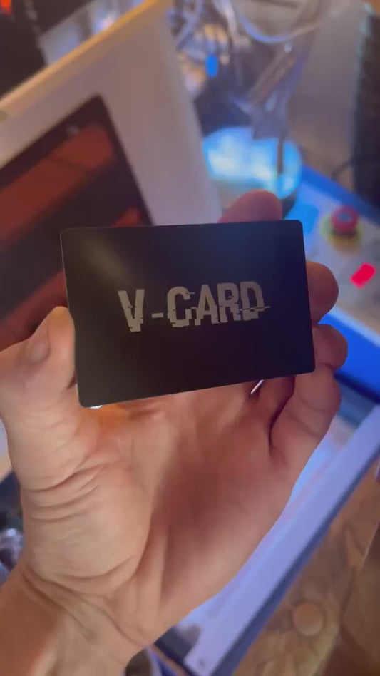 Close up video of hand holding a laser engraved metal gift card with V Card funny sarcastic text
