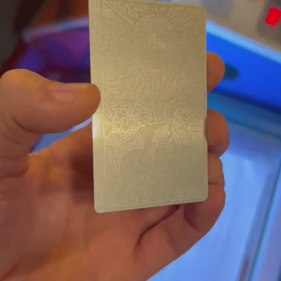 Custom anodized aluminum card being rotated to highlight the tarot card design