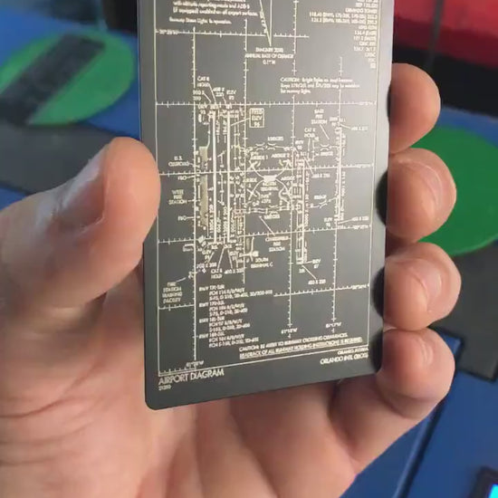 Video of hand holding a Metal airport diagram laser engraved aviation keepsake gift card