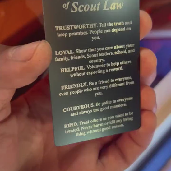 video of a hand holding and rotating a laser engraved metal 12 points of scout law 