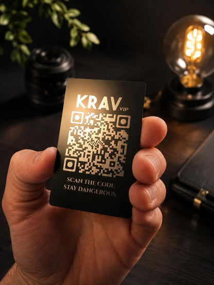 Hand holding a metal VIP card with a scannable QR code in black/silver