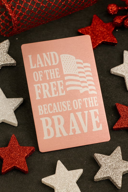 Metal Wallet Rose Gold/Silver Card with 'Land of the Free Because of the Brave' text surrounded by decorative stars on a dark background